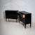 Pair of ebonized commodes with three drawers, raised on tapered square legs. The pieces were newly composed using earlier...