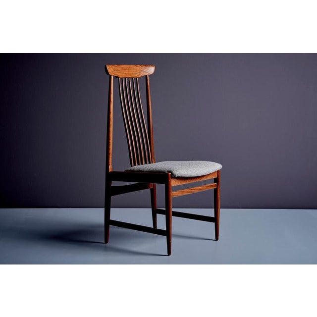 Set of 6 Danish design dining spindle back chairs in teak. The seats are upholstered in a grey salt and pepper fabric....