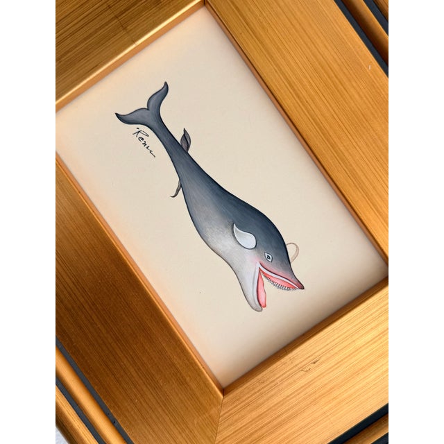 A playful hand-painted whale with a wonderfully expressive face, soft blue-gray shading, and charming pink details. Hand-...