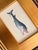 A playful hand-painted whale with a wonderfully expressive face, soft blue-gray shading, and charming pink details. Hand-...