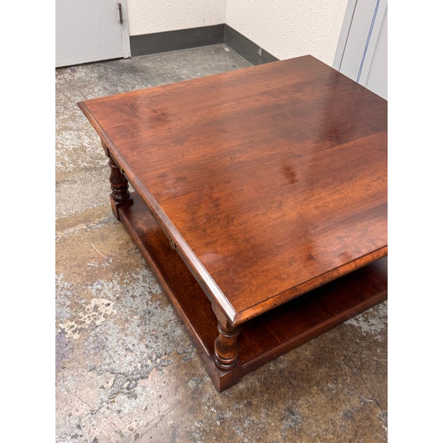 Design Plus Gallery presents the Refectory Coffee Table from Southworth Interiors. This square wood table has a broad...