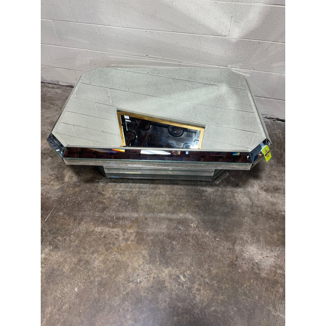 Very unusual, mid-century deco style mirrored coffee table. The top is beveled around the edges and is several inches...