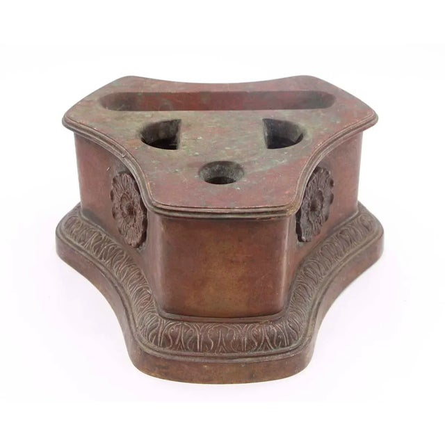 Fireplace tool holder made of solid bronze with floret and foliate details. The manufacturer and exact date of creation...