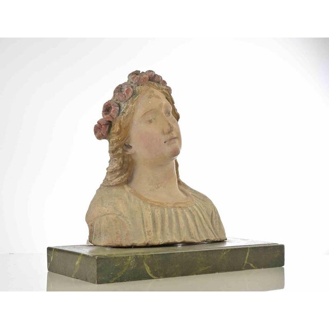 Ancient terracotta hand painted sculpture realized in Italy in 17th Century. Very good condition, placed on a marbelized...