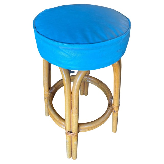 Restored single stand arched rattan bar stool comprised of 4 arches with a bottom foot rest connected to a dark green...