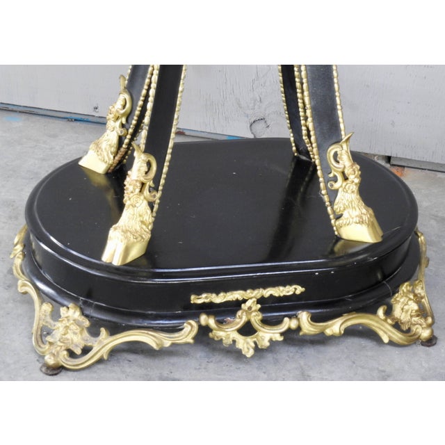 Featured are an elaborate pair of black enameled goat feet pedestals from the late 19th century. The feet are gilded...