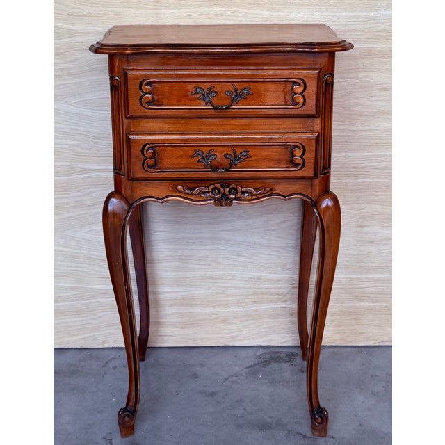 A fine pair of French bedside end tables or nightstands - each Stand featuring a scalloped edge gallery over a frieze of...
