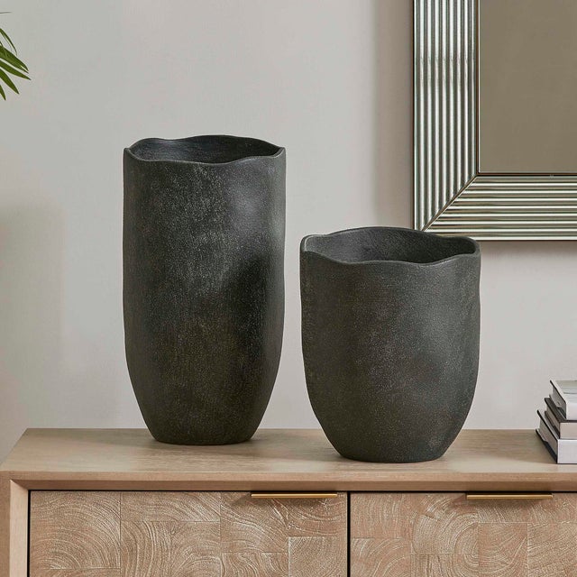 This Set Of Two Earthenware Vases Features A Striking Matte Black Finish With A Rich, Rustic Texture. Their Unique,...