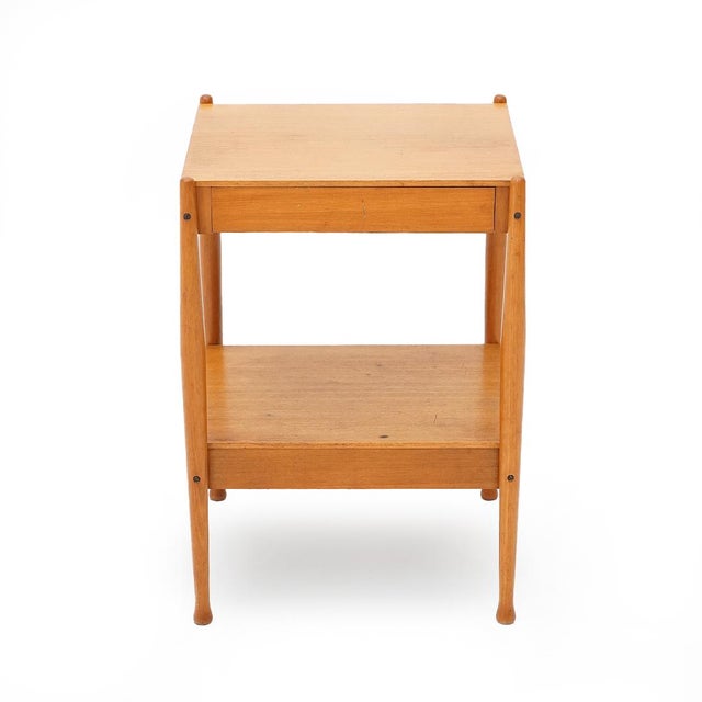 Italian-made bedside table produced in the 1960s by Fratelli Reguitti. Legs in shaped solid teak. Upper and lower shelves...