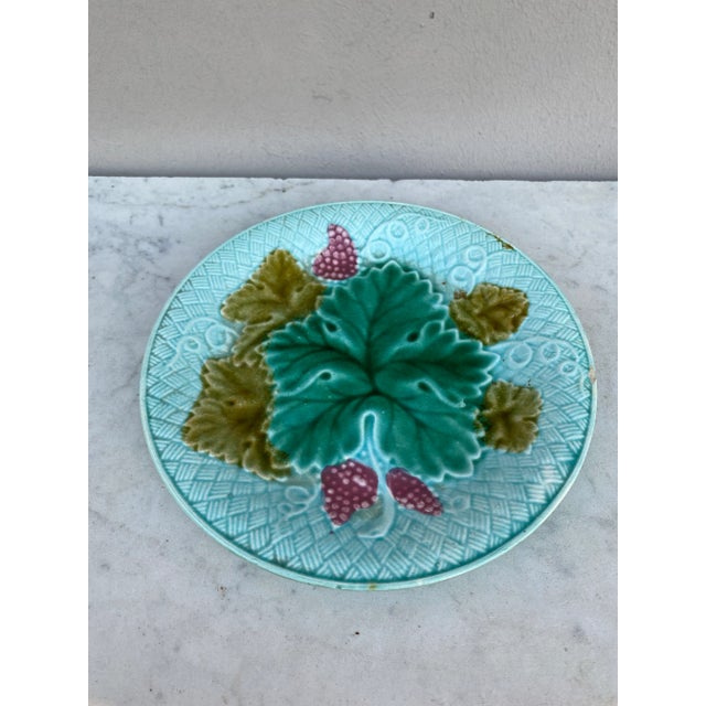 French Majolica grapes plate Salins on a light yellow background (East of France), circa 1890.