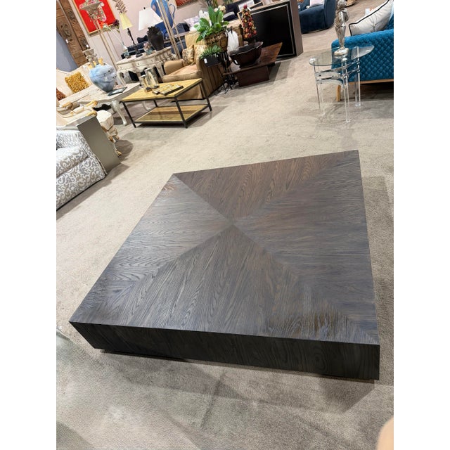 A bold and sculptural statement piece, this Restoration Hardware “Machinto” square coffee table features a striking...