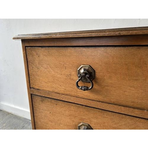 A small early 20th century Georgian style oak chest of drawers with a simple clean design and bevelled top and corners....