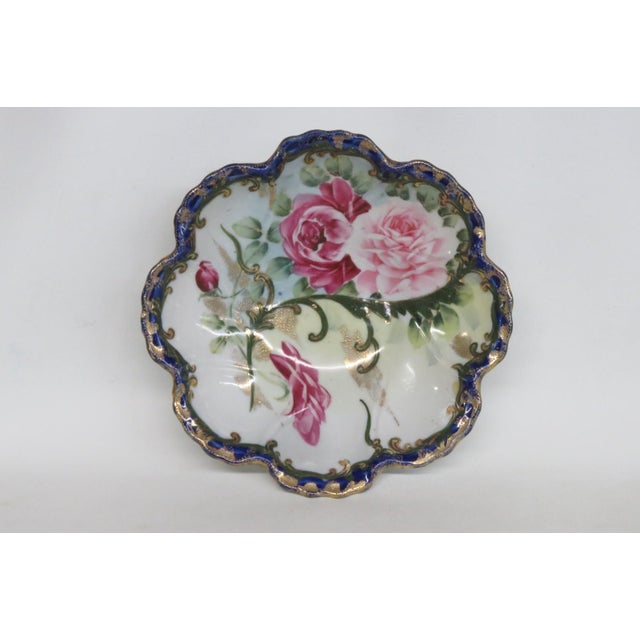 This gorgeous Scalloped Painted Dish is made of porcelain. This stunning piece features a hand painted bouquet motif of...