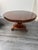 Large Regency antique mahogany tilt top dining table featuring a triform base resting on carved pedestal with three...