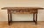 Spanish walnut drop-leaf table dating from the 1930s. This versatile piece can be used closed as a narrow table and...