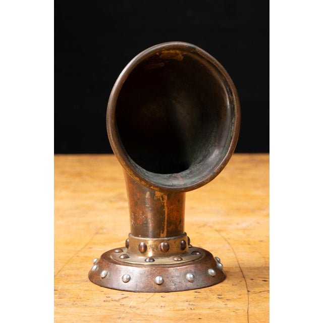 Early 20th-century marine cowl ventilator constructed from copper with a riveted brass collar and circular flanged base....