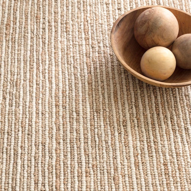 Like stripes of bark layered with ivory this rug brings rustic earthy charm to any interior. Low profile with dramatic...