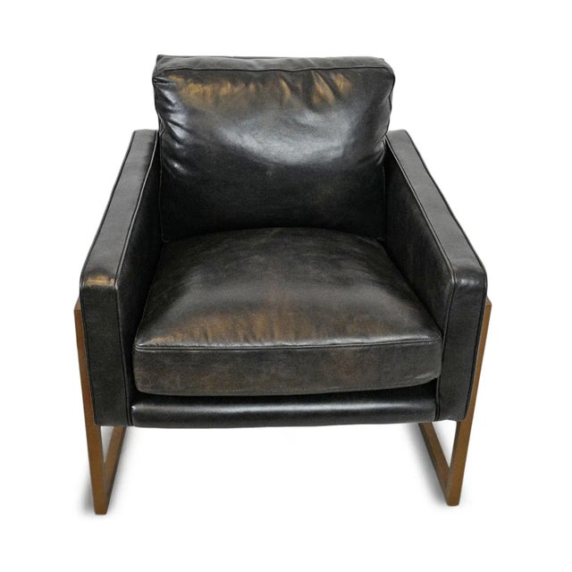Rich black top grain leather club chair set in a modern brass bronze finish iron base. Aged and distressed finish may vary...