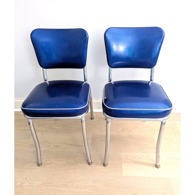 A pair of royal electric blue vintage diner chairs by the Richardson Seating Corporation. They are made of chrome and...