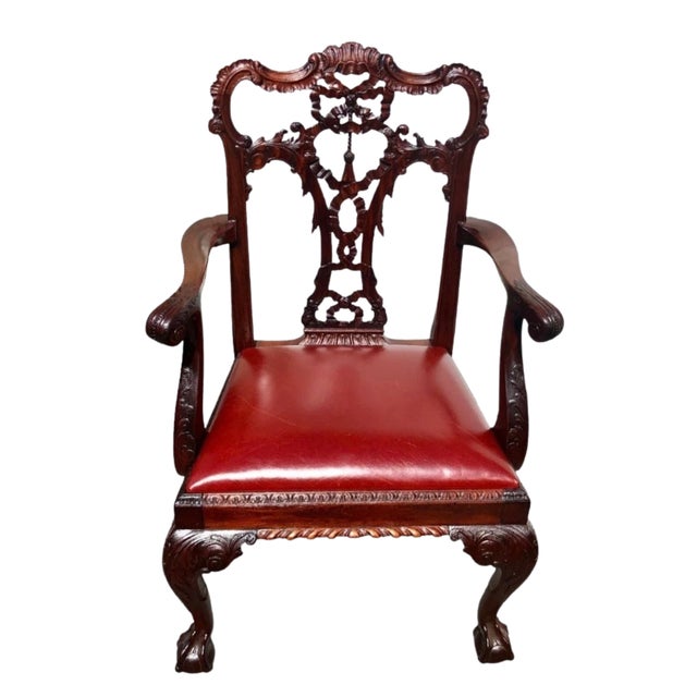 A distinguished set of eight English George III style carved mahogany dining chairs, circa 1870. The set includes two...
