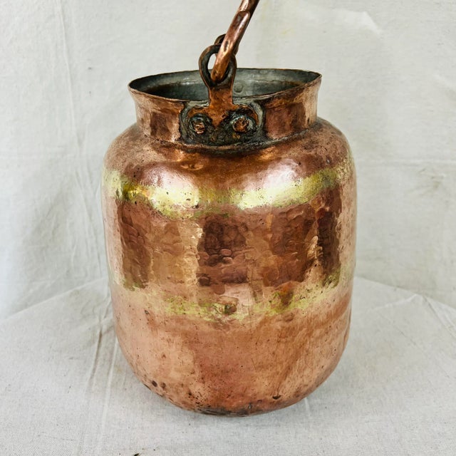 Handmade mid century copper container with handle. 9.5” diameter x 12” high, 17” with handle. Mouth measures 6.5” diameter.