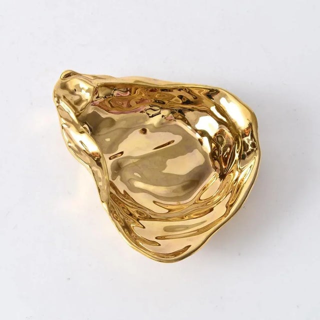 Small gold plated porcelain plate (bowl) shaped like an oyster shell. This piece has an attribution mark, I am sure that...