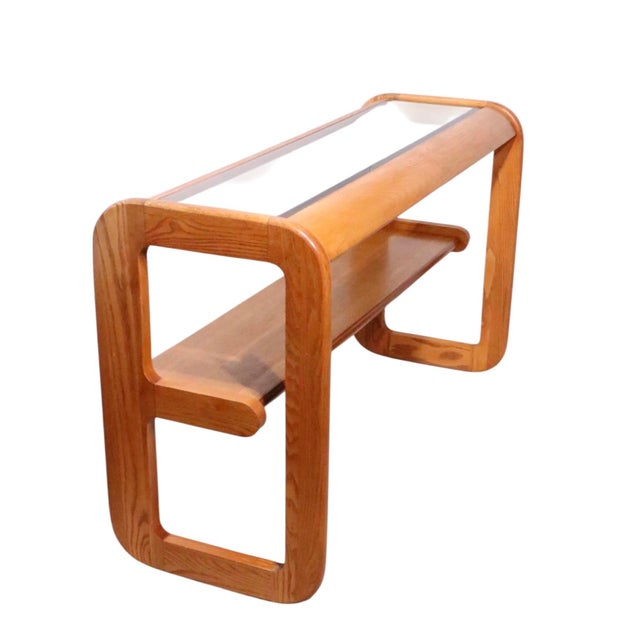 Classic late mid century design oak and tinted glass console table, designed by Lou Hodges, circa 1970's. This example is...