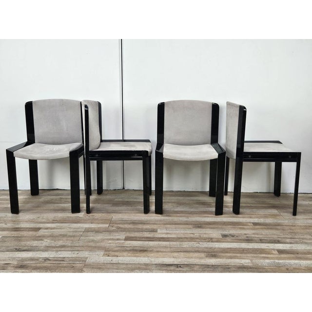 Set of four black lacquered wood chairs with gray fabric seat and back, designed by Joe Colombo in 1966 for Pozzi Milano....