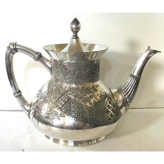 Meriden Britannia Co. 1880's silver plated aesthetic pattern teapot and creamer. The body decorated with an asymmetrical...