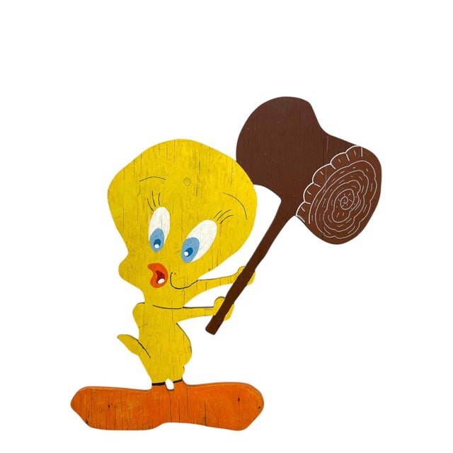 A whimsical vintage hand-painted wooden cutout featuring the classic cartoon character Tweety Bird holding an oversized...