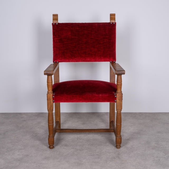 Historic oak armchair in very good condition. The burgundy-colored upholstery and carved legs are excellent. A beautiful,...