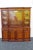 This Two Part Breakfront China Cabinet is made of wood, solid wood, mahogany, flame mahogany, veneer, leather, and glass....