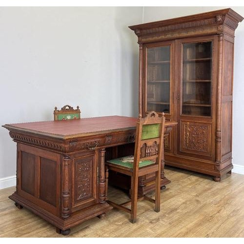 An impressive Antique French double sided desk in Oak, featuring richly carved pedestal fronts, turned column details and...