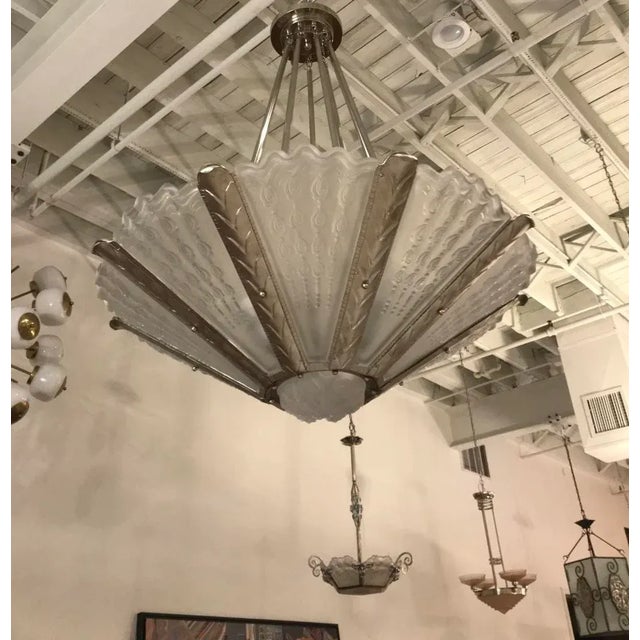 Stunning French Art Deco chandelier by the French artist Gênet et Michon. Having nine panels with a center coupe in clear...