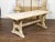 A rustic English natural wood farm table from the 19th century, with trestle base and weathered patina. Created in England...