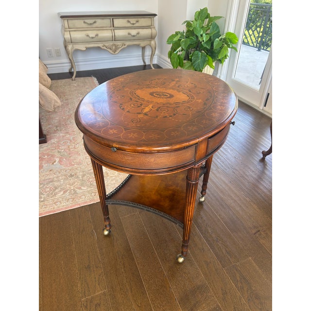 A beautifully crafted marquetry inlaid center table featuring intricate detailing and timeless appeal. The tabletop...