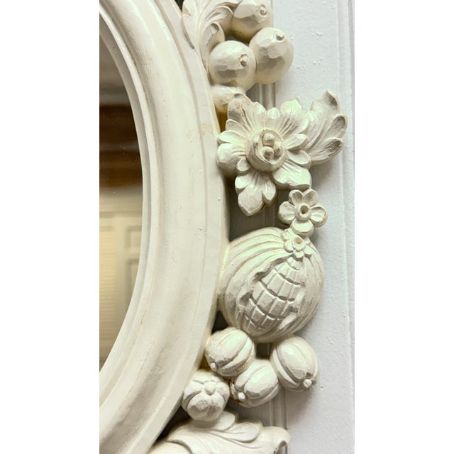 25 x 30" Antique white mirror with floral and fruit motif.