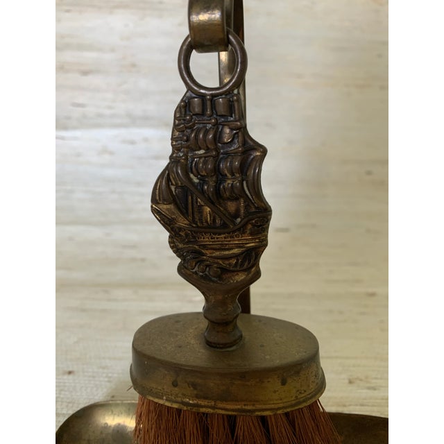 Unique brass fireplace tool set with the Mayflower ship on handle. Tools include brush and a pan.
