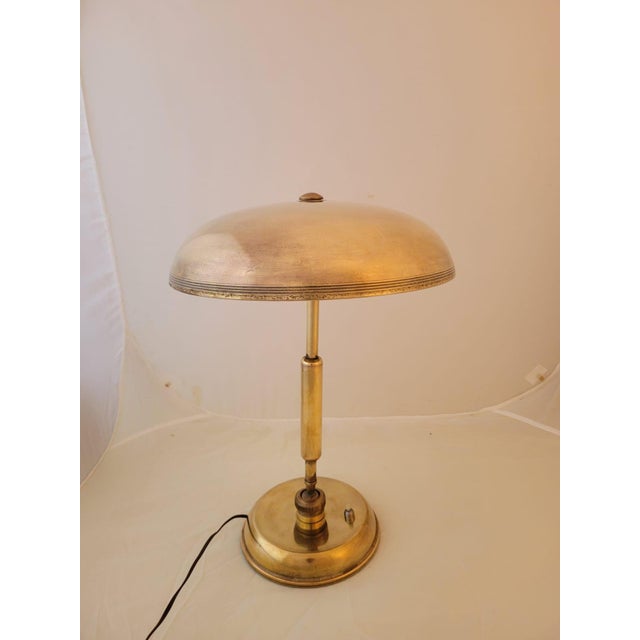 Brass table lamp from the 1940s, designed by Giovanni Michelucci for Lariolux. The lamp features a characteristic...