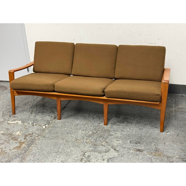 Design Plus Gallery presents a Circa 1960's Danish Three Seater Sofa from Komfort. The sofa has a teak frame with an open...