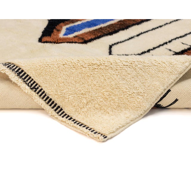 Eclectic hand-knotted wool rug with an abstract design, blending Midnight Black, Rust Brown, and Blue on an Ivory canvas....