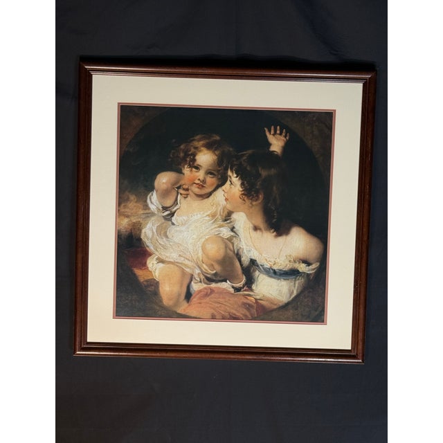 A classic portrait-style framed wall art piece with a warm traditional composition, cream matting, and a dark brown wood...