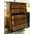 Traditional-style chest crafted in a warm, medium-toned wood finish with decorative moldings, fluted corner details, and...