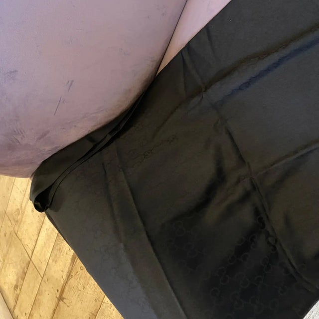 An elegant italian black scarf designed and manufactured in Italy by Gucci in perfect conditions. The scarf has been...