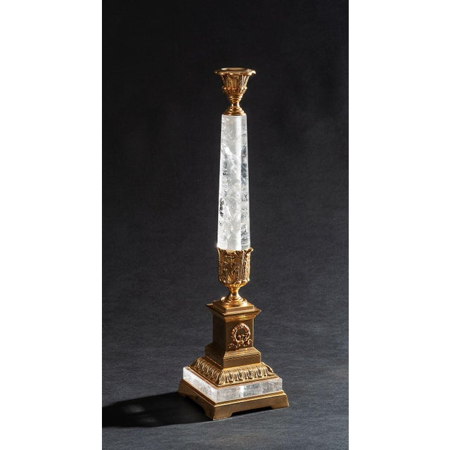 An elegant Italian candlestick crafted with a substantial rock crystal column and finely detailed bronze fittings plated...