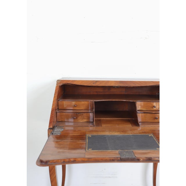 An elegant 18th-century French lady’s writing desk, or bureau de dame, crafted in warm walnut with graceful cabriole legs...