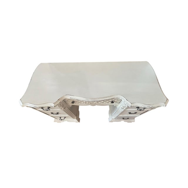 A beautifully refinished French Provincial-inspired vanity or writing desk paired with its coordinating carved mirror,...