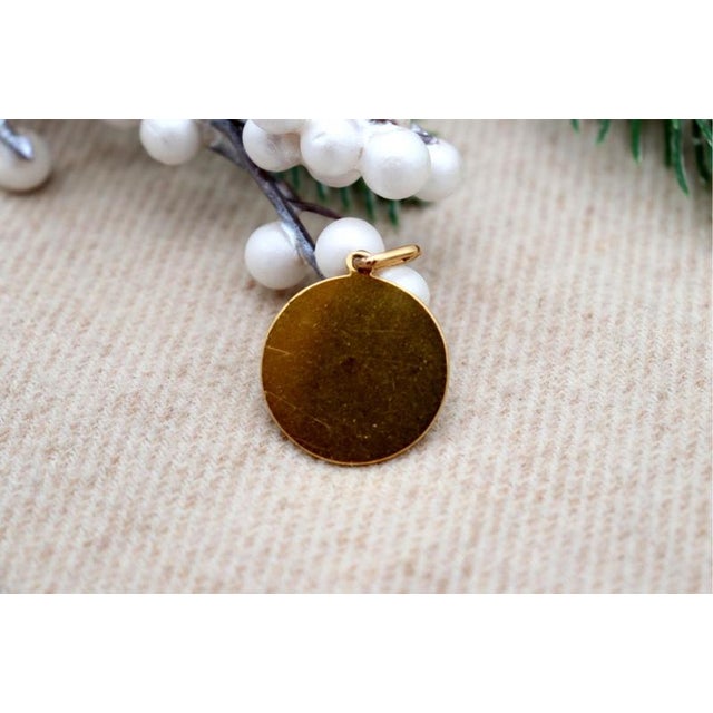 Saint Teresa 19.2k Gold Pendant, in Worn conditions. Designed 1920 to 1949