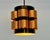 A sculptural vintage pendant lamp attributed to Danish lighting manufacturer Coronell Elektro. Its cylindrical form...