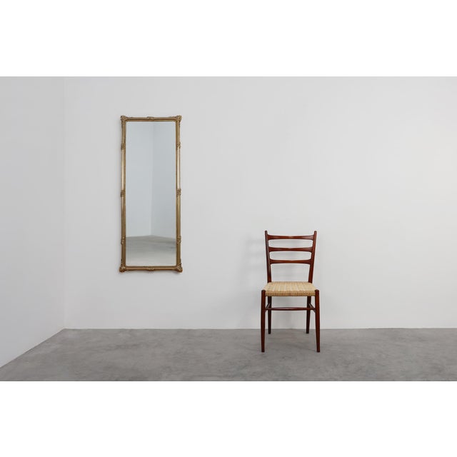 This large French Neo‑Classical mirror from the 20th century combines architectural elegance with a warm, sculptural...